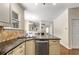 Spacious kitchen and bar area with stainless steel dishwasher and cream-colored cabinetry at 825 Yosemite Dr, Suwanee, GA 30024