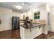 Stylish kitchen features stainless steel appliances, granite countertops, and a breakfast bar at 825 Yosemite Dr, Suwanee, GA 30024