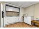 The kitchenette has white cabinets, tile backsplash, counter space, a microwave, and a refrigerator at 825 Yosemite Dr, Suwanee, GA 30024