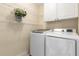 Convenient laundry room with washer, dryer, and shelving for storage at 825 Yosemite Dr, Suwanee, GA 30024