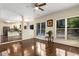 Open-concept living area leads to kitchen, featuring hardwood floors and a bright, airy atmosphere at 825 Yosemite Dr, Suwanee, GA 30024
