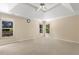 Spacious main bedroom with tray ceiling and multiple windows at 825 Yosemite Dr, Suwanee, GA 30024