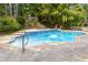 A private in-ground pool with a stone surround and mature landscaping offers a backyard oasis at 825 Yosemite Dr, Suwanee, GA 30024