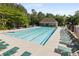 Community pool with many lounge chairs and lifeguard stand, close to clubhouse at 825 Yosemite Dr, Suwanee, GA 30024