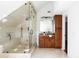 Modern bathroom features a glass-enclosed shower with bench seating, vanity with storage, and neutral finishes at 118 Waverly Way, Atlanta, GA 30307