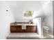 Bright bathroom features a soaking tub with granite surround, skylight, and modern fixtures at 118 Waverly Way, Atlanta, GA 30307