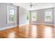 Bright bedroom with hardwood floors, three windows, and neutral walls at 118 Waverly Way, Atlanta, GA 30307