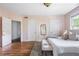 Bedroom with hardwood floors, a large bed, neutral color scheme, and large windows at 118 Waverly Way, Atlanta, GA 30307