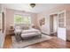 Comfortable pink bedroom featuring hardwood floors, a large bed, and natural light at 118 Waverly Way, Atlanta, GA 30307