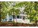 Beautiful two-story home with a classic design, a welcoming front porch, and mature trees at 118 Waverly Way, Atlanta, GA 30307