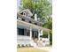 Close up of charming home featuring a welcoming front porch and a beautifully landscaped front yard at 118 Waverly Way, Atlanta, GA 30307