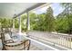Spacious covered front porch with ample seating and scenic views of the lush surroundings at 118 Waverly Way, Atlanta, GA 30307