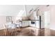 Contemporary kitchenette features stainless appliances, granite counters, sleek white cabinetry, and dining table at 118 Waverly Way, Atlanta, GA 30307