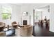 Bright living room with a fireplace, hardwood floors, and lots of natural light at 118 Waverly Way, Atlanta, GA 30307