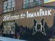Creative mural reading 'Welcome to Inman Park' with butterfly and forest artwork at 118 Waverly Way, Atlanta, GA 30307