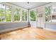 Light-filled sun room with multiple windows and a door at 118 Waverly Way, Atlanta, GA 30307