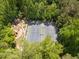 Aerial view of the tennis court and playground nestled in lush greenery at 11865 Brisbane Dr, Alpharetta, GA 30009