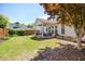 Expansive backyard with covered patio, stylish seating, mature tree, and well-maintained lawn at 11865 Brisbane Dr, Alpharetta, GA 30009