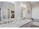 Bathroom featuring double sinks, granite countertops, a walk-in shower, and modern fixtures at 11865 Brisbane Dr, Alpharetta, GA 30009