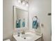 Cozy bathroom featuring a well-lit mirror, white vanity, and neutral colored walls at 11865 Brisbane Dr, Alpharetta, GA 30009