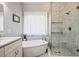 Bathroom featuring a tub, a separate glass shower, and a sink with stone countertop at 11865 Brisbane Dr, Alpharetta, GA 30009