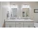 Bathroom featuring double sinks, granite countertops, a walk-in shower, and modern fixtures at 11865 Brisbane Dr, Alpharetta, GA 30009