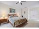 Carpeted bedroom features a ceiling fan, a bed, and natural light from the windows at 11865 Brisbane Dr, Alpharetta, GA 30009