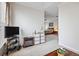 Bright living area leading to bedroom with king bed, nightstands, and painting at 11865 Brisbane Dr, Alpharetta, GA 30009