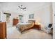Spacious bedroom features a ceiling fan, carpet, a bed, two nightstands, and natural light from the windows at 11865 Brisbane Dr, Alpharetta, GA 30009
