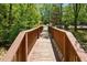 Take a stroll on the bridge which has views of the community playground and tennis courts at 11865 Brisbane Dr, Alpharetta, GA 30009