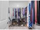 Organized walk-in closet with hanging clothes, shoe racks, and a clean, neutral color scheme at 11865 Brisbane Dr, Alpharetta, GA 30009