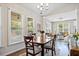 Bright dining room with hardwood floors, table set for four, large windows, and an open floor plan at 11865 Brisbane Dr, Alpharetta, GA 30009