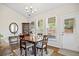 Charming dining room featuring hardwood floors, a dining table set, and natural light from bright windows at 11865 Brisbane Dr, Alpharetta, GA 30009