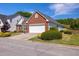 Charming brick home with well-manicured lawn, lush shrubbery, and attached two-car garage at 11865 Brisbane Dr, Alpharetta, GA 30009
