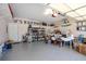 Spacious garage with epoxy flooring, shelving, storage containers, and ample room for organization at 11865 Brisbane Dr, Alpharetta, GA 30009