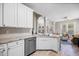 Well-designed kitchen with white cabinetry, stainless steel appliances, and seamless flow into living areas at 11865 Brisbane Dr, Alpharetta, GA 30009