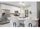 Modern kitchen featuring white cabinets, stainless steel appliances, granite countertops, and a stylish island at 11865 Brisbane Dr, Alpharetta, GA 30009