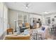 Open-concept living room featuring a ceiling fan, hardwood-style floors, and stainless steel kitchen appliances at 11865 Brisbane Dr, Alpharetta, GA 30009