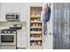 Well-organized pantry features pull-out drawers and shelves for efficient storage in this bright, modern kitchen at 11865 Brisbane Dr, Alpharetta, GA 30009