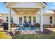 Charming covered patio with comfortable seating, inviting rug, and view of the backyard at 11865 Brisbane Dr, Alpharetta, GA 30009