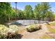 Community tennis court surrounded by greenery for a private playing experience at 11865 Brisbane Dr, Alpharetta, GA 30009
