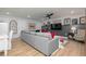 Finished basement with a large sectional sofa, wood floors, and entertainment area at 1717 Cosette Ln, Kennesaw, GA 30152
