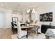 Inviting dining area with modern lighting and seamless connection to the kitchen and living spaces at 1717 Cosette Ln, Kennesaw, GA 30152