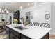 Open-concept kitchen with a central island, modern sink, and seamless connection to dining and living spaces at 1717 Cosette Ln, Kennesaw, GA 30152