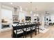 Modern kitchen featuring a central island, stylish pendant lights, and seamless flow to the living area at 1717 Cosette Ln, Kennesaw, GA 30152