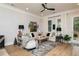 Cozy living room with neutral tones, comfortable seating, decorative rug, and plenty of natural light at 1717 Cosette Ln, Kennesaw, GA 30152