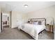 Neutral bedroom featuring carpet, natural light, and ensuite bathroom entrance at 209 Starr Cir, Stockbridge, GA 30281