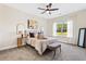 Bright bedroom with large windows, neutral decor, a ceiling fan, and stylish furnishings create a cozy and inviting atmosphere at 209 Starr Cir, Stockbridge, GA 30281