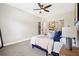 A serene bedroom with plush carpeting, neutral walls, and a modern ceiling fan for a relaxed and comfortable ambiance at 209 Starr Cir, Stockbridge, GA 30281
