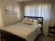 Neutral bedroom with a modern bed, soft lighting, and decorative art at 3385 Martin Luther King Jr Sw Dr, Atlanta, GA 30331